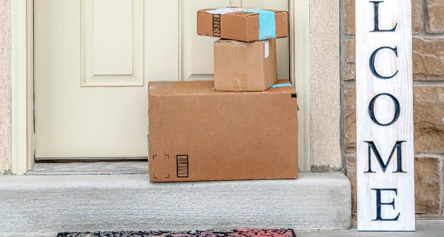 Packages on the doorstep of a home with a welcome sign in Myrtle Beach